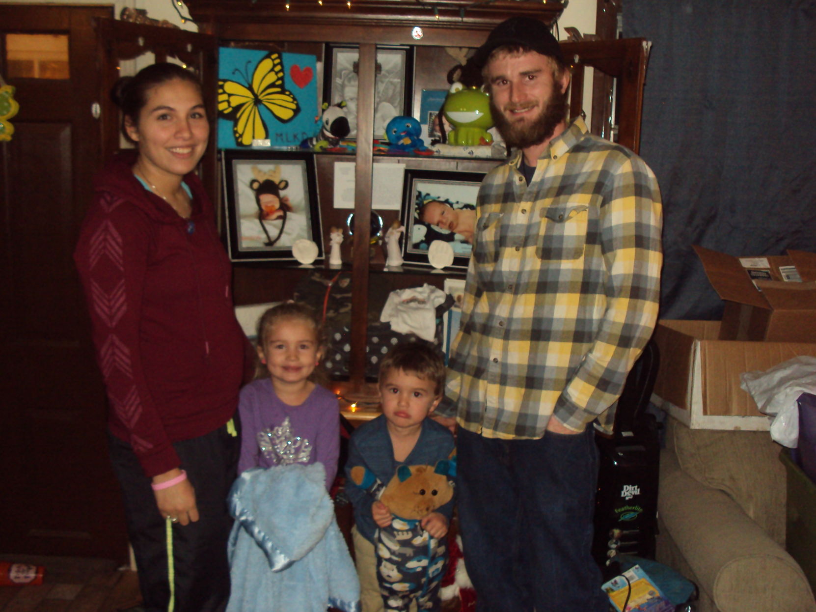 Wardtown Mobile Home Park Co-op's Patricia and Todd Donahue and their children, Raelyn, left, and Tripp, with keepsakes from Mason Donahue, who died at 36 days old from sudden infant death syndrome in May.