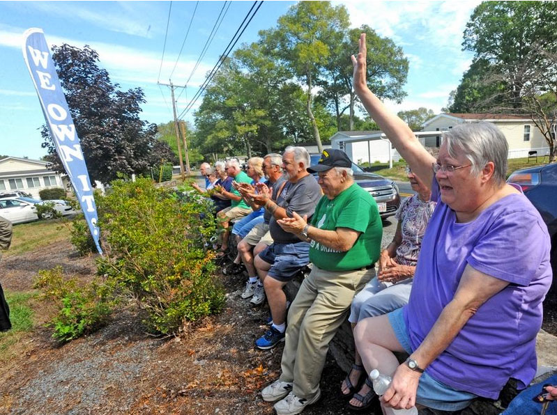 Residents celebrate becoming owners of Colonial Estates. Photo by Mike Gay for Taunton Gazette.