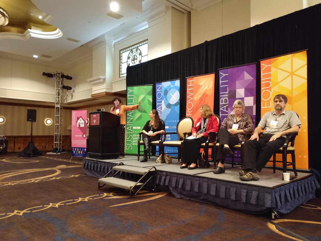 Noemi Giszpenc presenting on a panel at the 2018 Cooperative Impact Conference, along with Alex Stone, Kim Coontz, Jan Sage, and Stuart Reid