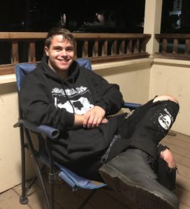 Photo of Eric sitting on his balcony